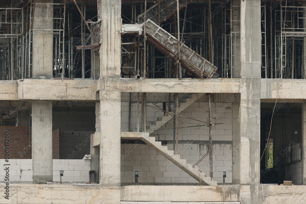 Unfinished cement building at a construction site.Cement pouring into formwork of building at construction site.A new residential build concept.