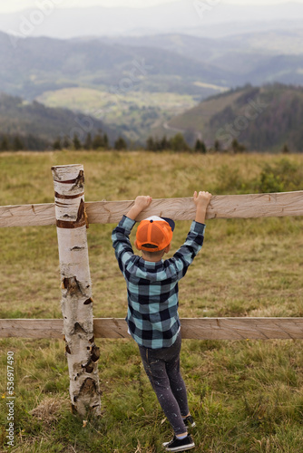 Wallpaper Mural Boy wearing cap playing by fence at farm Torontodigital.ca