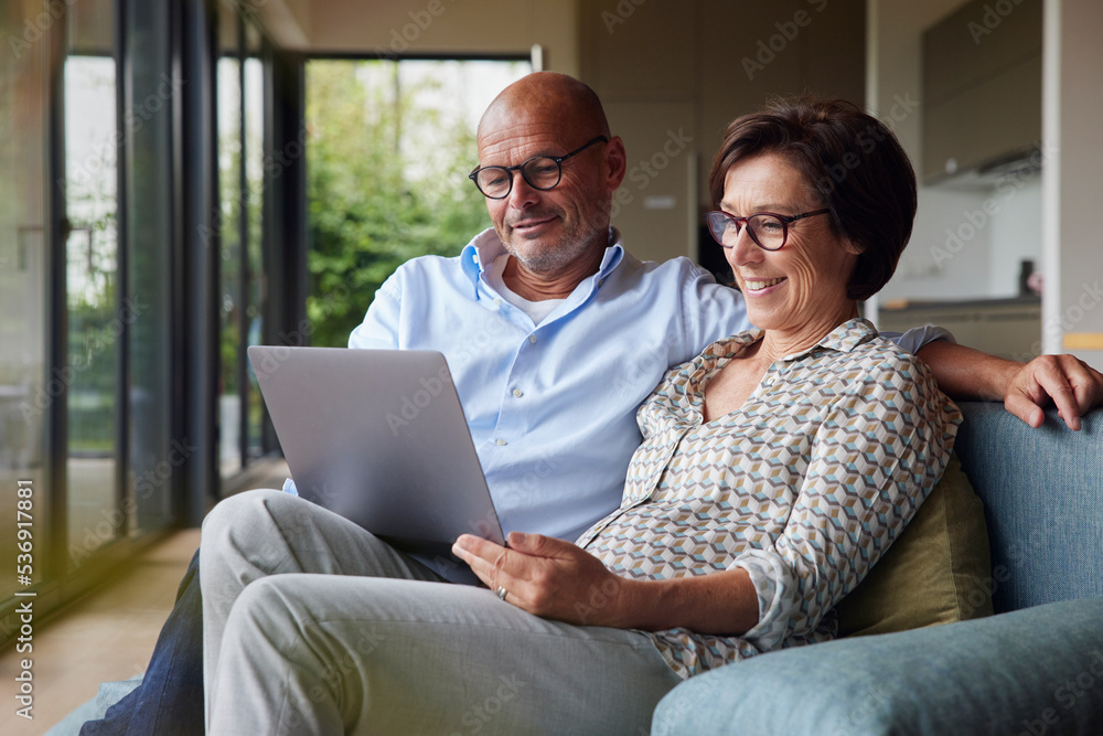 Happy senior woman with man using laptop at home Happy senior woman with man using laptop at home
