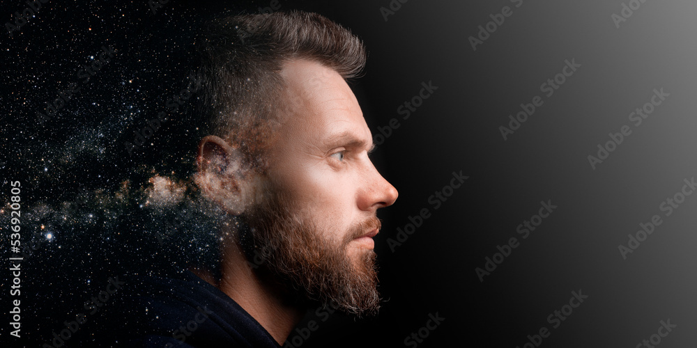 a man who marvels into the distance on a black background with the effect of double exposure.