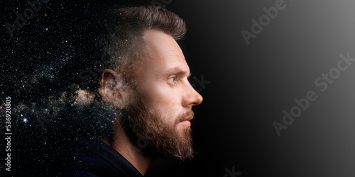 a man who marvels into the distance on a black background with the effect of double exposure.