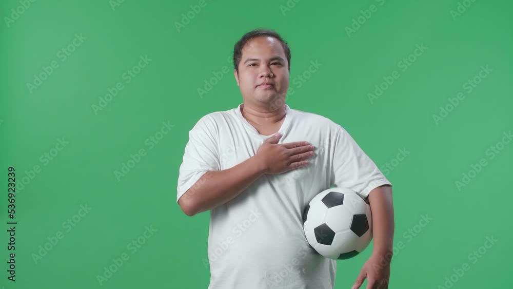 Asian Man With A Ball Putting Hand On His Heart To Respect The National Flag And Anthem While Cheering Soccer On Green Screen Background
Asian Man With A Ball Putting Hand On His Heart To Respect The National Flag And Anthem While Cheering Soccer On Green Screen Background