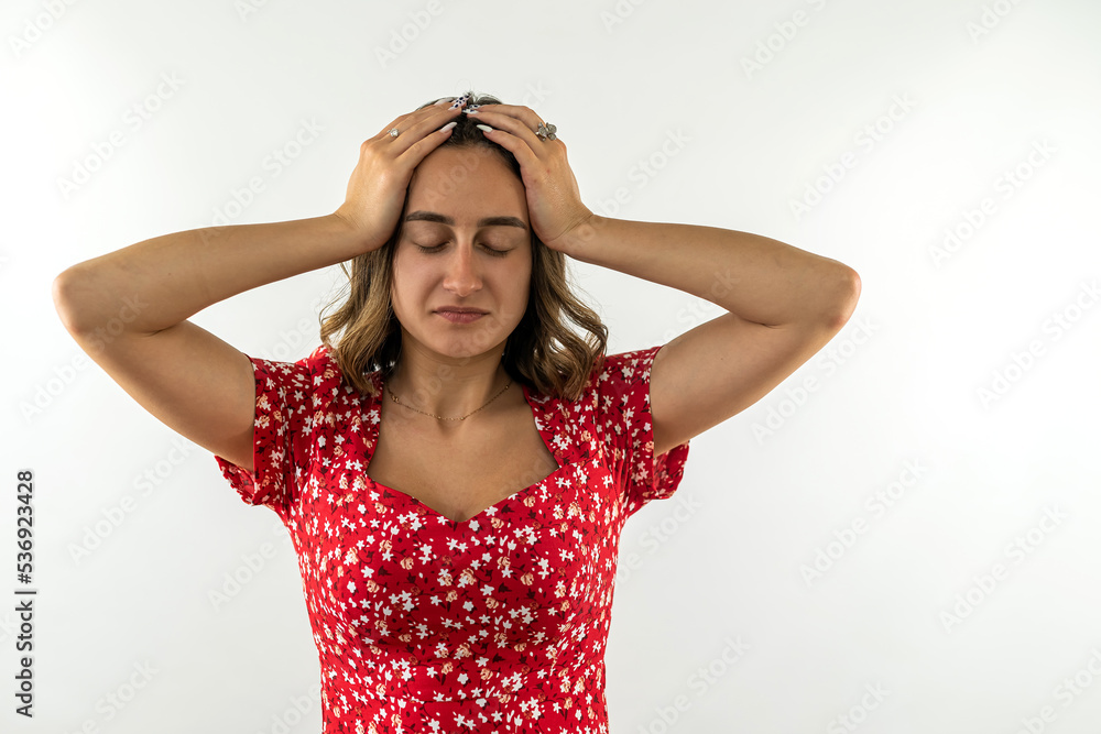 woman suffering fro headache holding her hands behind her head isolated on a white background woman suffering fro headache holding her hands behind her head isolated on a white background