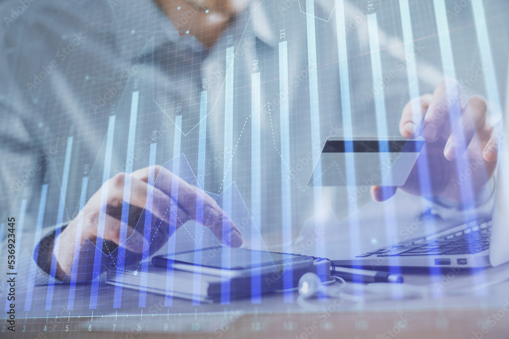 Double exposure of man hands holding a credit card and Forex graph drawing. Stock trading and digital fintech in Internet E-commerce concept. Double exposure of man hands holding a credit card and Forex graph drawing. Stock trading and digital fintech in Internet E-commerce concept.