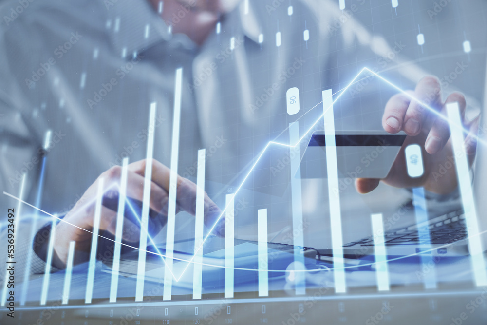 Double exposure of man hands holding a credit card and Forex graph drawing. Stock trading and digital fintech in Internet E-commerce concept. Double exposure of man hands holding a credit card and Forex graph drawing. Stock trading and digital fintech in Internet E-commerce concept.