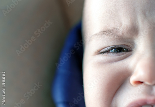 face details parts of baby boy child kid.angry nervous toddler crying out whims airs and graces.close up eye mouth first milk teeth lips.infant frownies forehead wide open mouth.cute beautiful baby photo