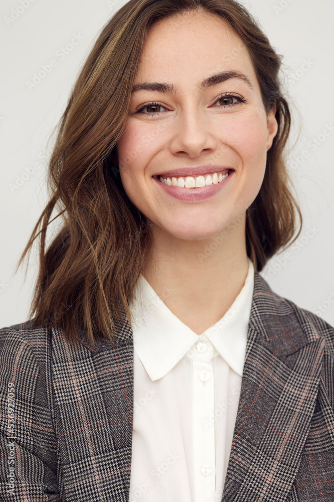 Portrait of young happy beautiful woman smiling and standing isolated on white background looking professional. Confident businesswoman with perfect smile looking in camera. Portrait of young happy beautiful woman smiling and standing isolated on white background looking professional. Confident businesswoman with perfect smile looking in camera.
