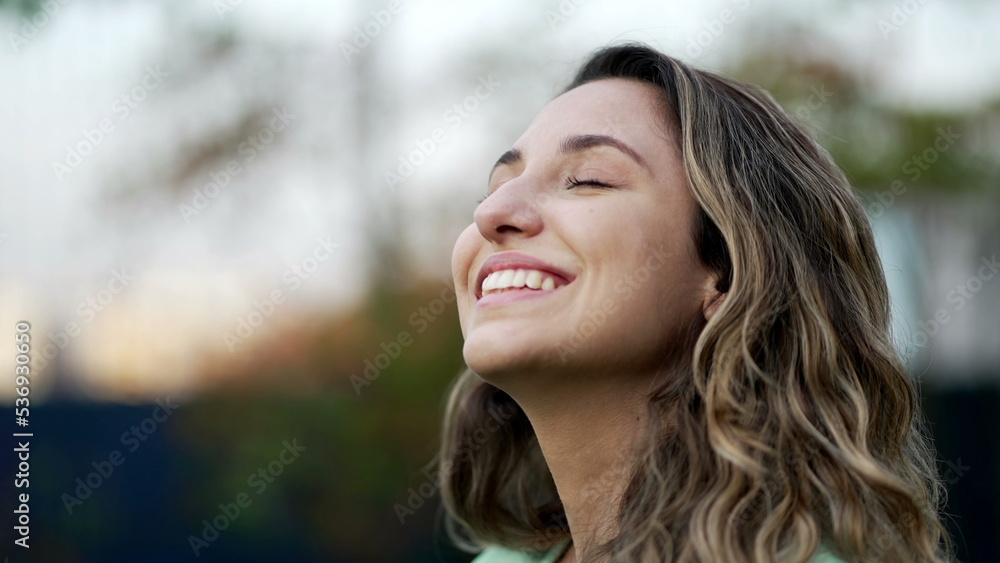 Portrait of a grateful contemplative young woman closeup face. Meditative 20s girl opening eyes to sky with gratitude Portrait of a grateful contemplative young woman closeup face. Meditative 20s girl opening eyes to sky with gratitude