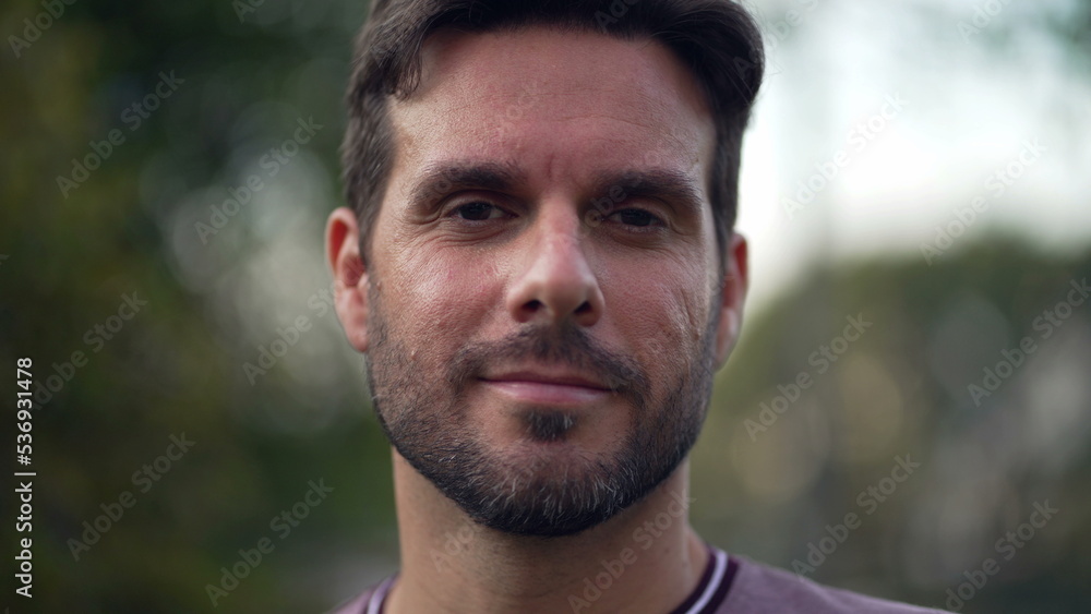 Head shot portrait young smiling handsome european appearance man standing outdoors. guy outside in nature. Tracking shot Head shot portrait young smiling handsome european appearance man standing outdoors. guy outside in nature. Tracking shot