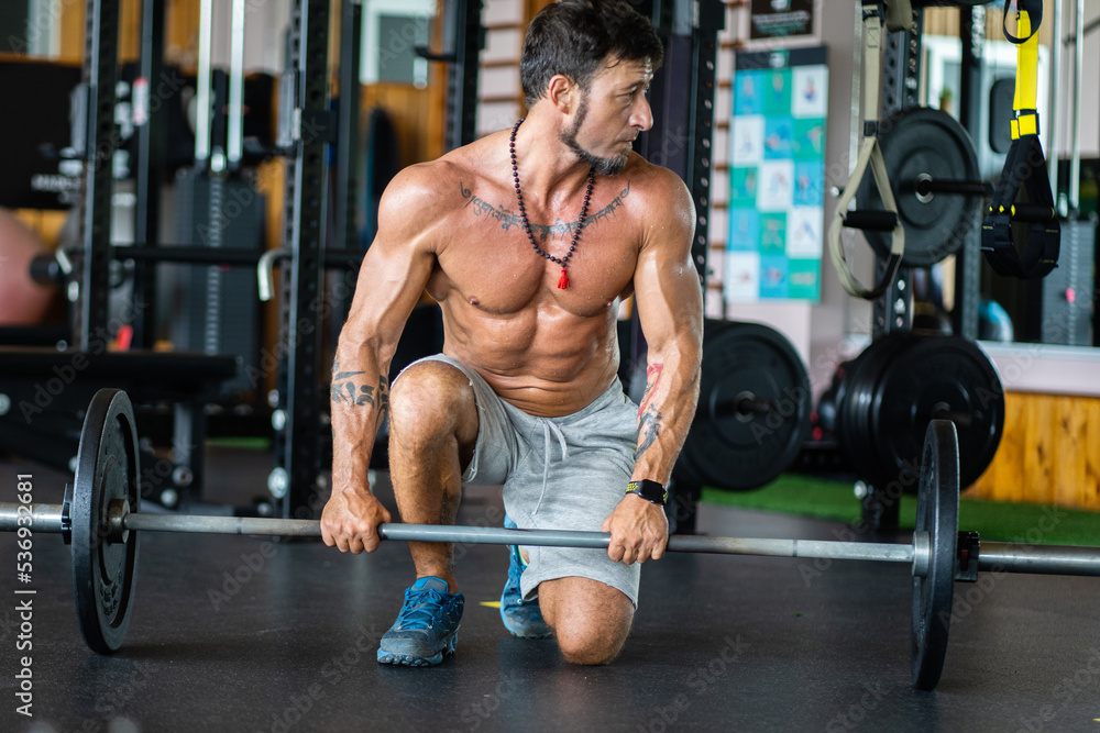 Man resting in a gym while exercising Man resting in a gym while exercising