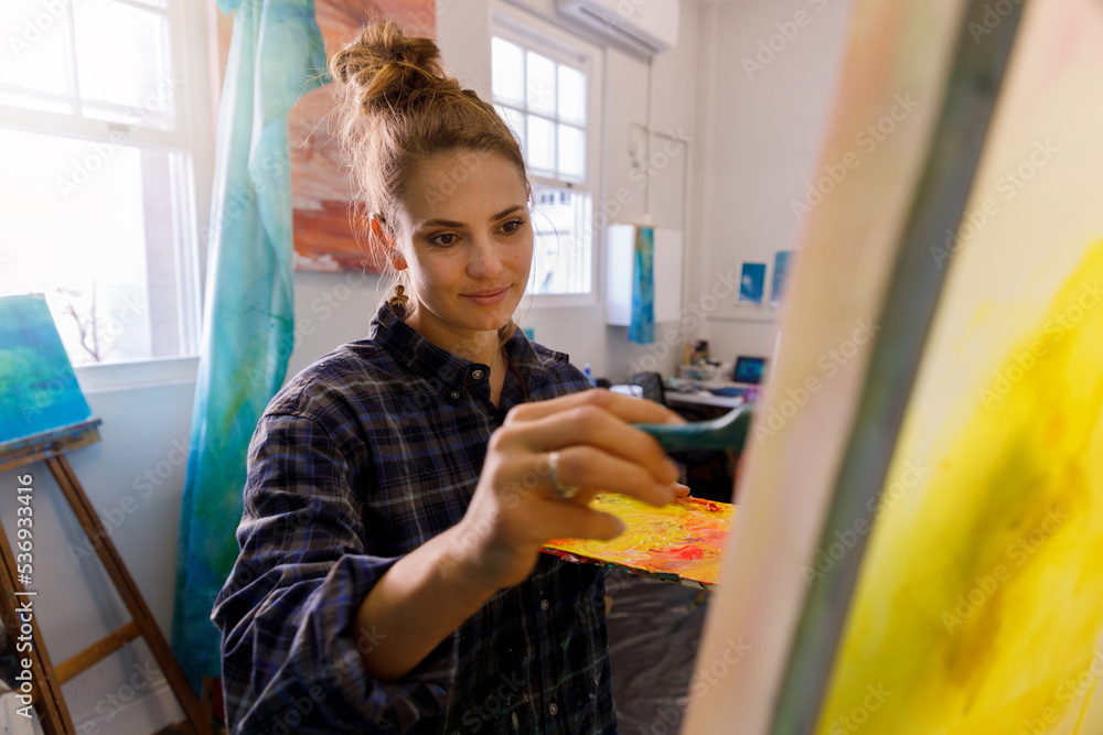 Portrait of Female Artist Works on Abstract Oil Painting, Moving Paint Brush Energetically She Creates Modern Masterpiece. Portrait of Female Artist Works on Abstract Oil Painting, Moving Paint Brush Energetically She Creates Modern Masterpiece.