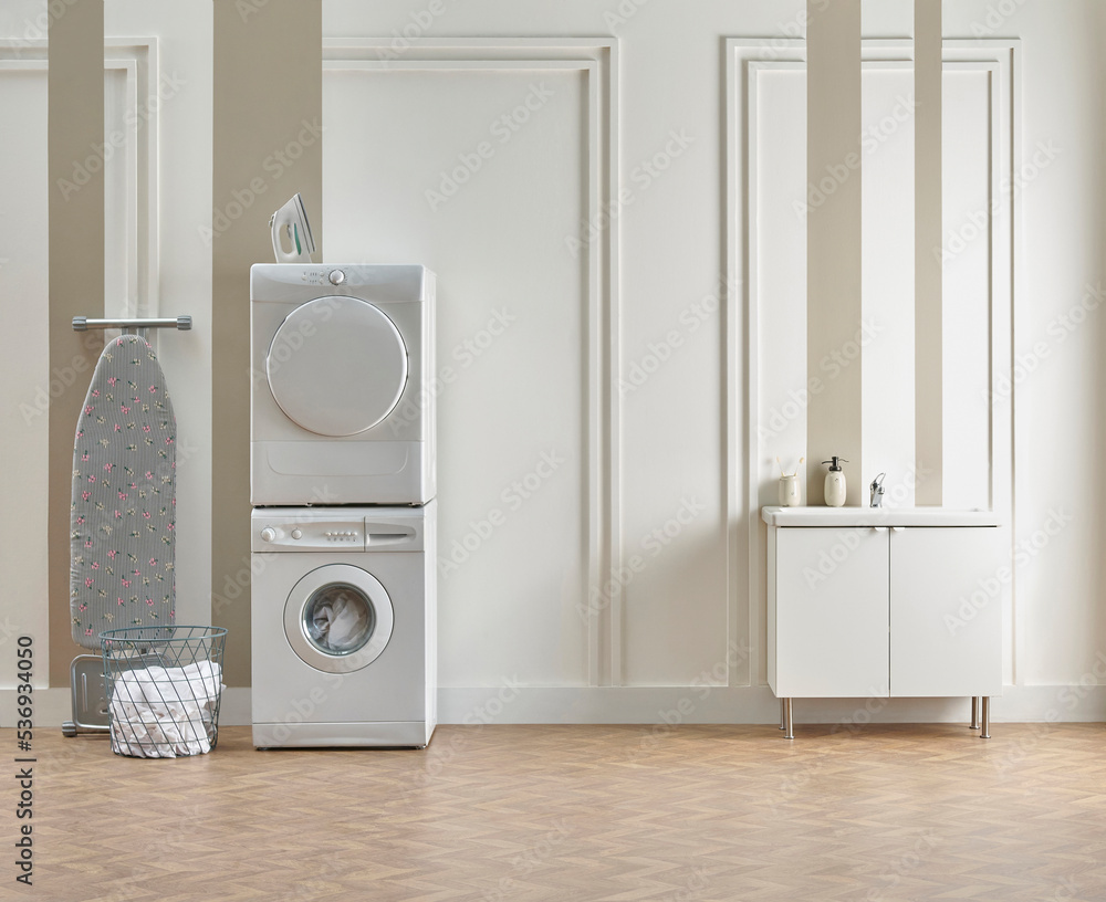 Washing dryer machine and ironing table interior style, laundry room, white and brown vertical wall background. Washing dryer machine and ironing table interior style, laundry room, white and brown vertical wall background.