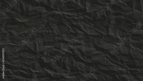 Creative background with scattered overlay of crumpled black paper.