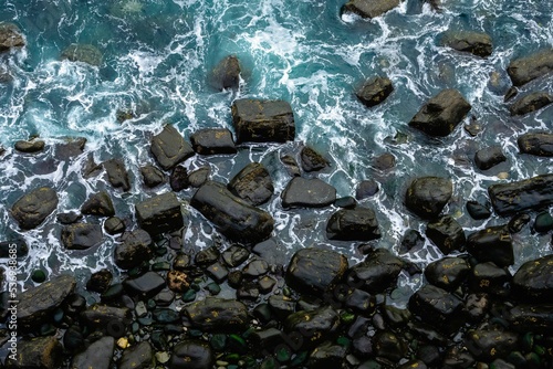 Blue water surface with rocks.  Mealt Falls, Isle of Skye, Scotland, UK. photo