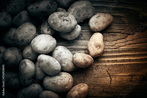 Potatoes over wooden vintage backdrop