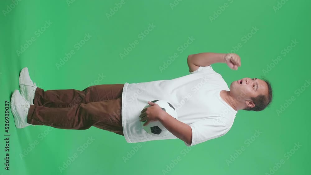 Full Body Of Asian Man With A Ball Screaming Goal Celebrating For The Winner Team While Cheering Soccer On Green Screen Background
Full Body Of Asian Man With A Ball Screaming Goal Celebrating For The Winner Team While Cheering Soccer On Green Screen Background