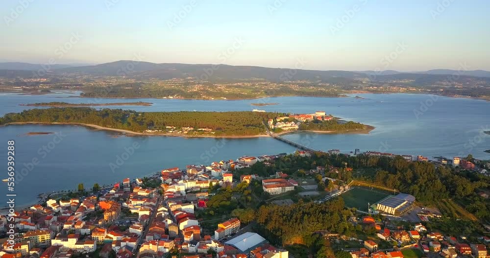 Aerial Flying Over O Grove Towards Illa da Toxa In Galicia at sunset. Dolly Forward