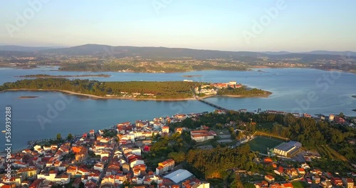 Aerial Flying Over O Grove Towards Illa da Toxa In Galicia at sunset. Dolly Forward photo