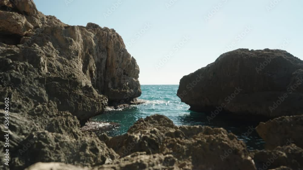 Rocks on the sides and sea waves between them, a sunny day. Rocks on the sides and sea waves between them, a sunny day.