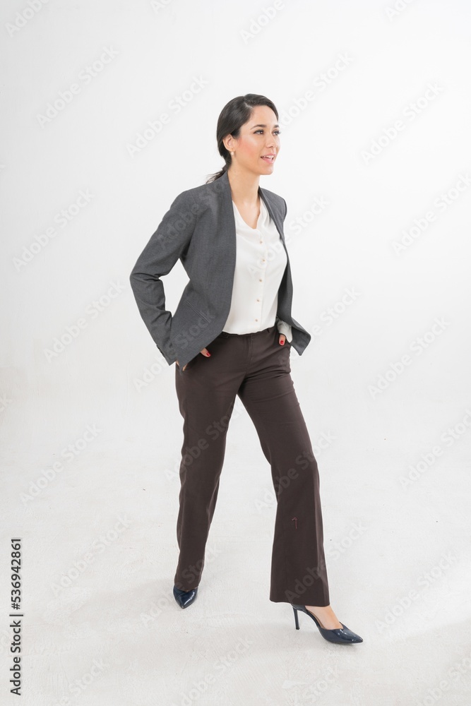 Studio portrait photo of a young beautiful elegant Brazilian female businesswoman lady wearing smart casual business attire suit posing with a series moments of emotion and gesture for all application Studio portrait photo of a young beautiful elegant Brazilian female businesswoman lady wearing smart casual business attire suit posing with a series moments of emotion and gesture for all application