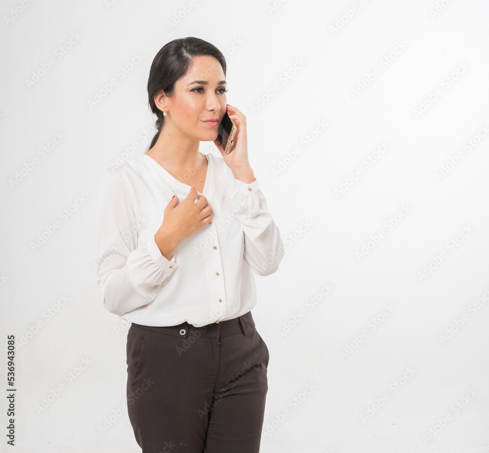 Studio portrait photo of a young beautiful elegant Brazilian female businesswoman lady wearing smart casual business attire posing with a series moments of emotion and gesture of using her smartphone Studio portrait photo of a young beautiful elegant Brazilian female businesswoman lady wearing smart casual business attire posing with a series moments of emotion and gesture of using her smartphone