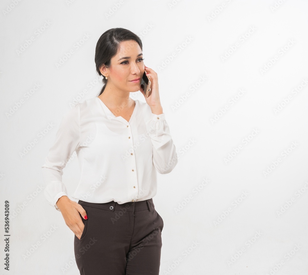 Studio portrait photo of a young beautiful elegant Brazilian female businesswoman lady wearing smart casual business attire posing with a series moments of emotion and gesture of using her smartphone Studio portrait photo of a young beautiful elegant Brazilian female businesswoman lady wearing smart casual business attire posing with a series moments of emotion and gesture of using her smartphone