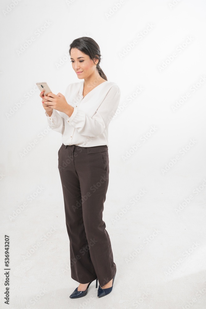 Studio portrait photo of a young beautiful elegant Brazilian female businesswoman lady wearing smart casual business attire posing with a series moments of emotion and gesture of using her smartphone Studio portrait photo of a young beautiful elegant Brazilian female businesswoman lady wearing smart casual business attire posing with a series moments of emotion and gesture of using her smartphone