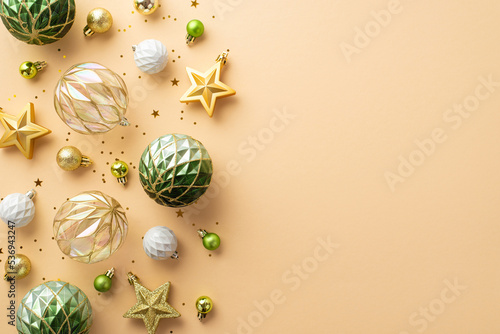 New Year decorations concept. Top view photo of transparent white gold and green baubles star ornaments and confetti on isolated beige background with copyspace