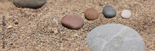 Footprint of stones in the sand, close-up, blurry