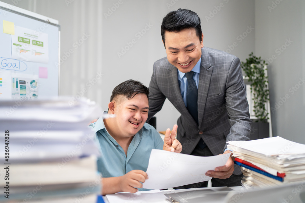 Asian young businessman with down syndrome working in office workplace. Asian young businessman with down syndrome working in office workplace.