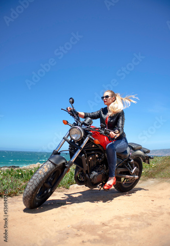 attractive woman on motorcycle outdoors