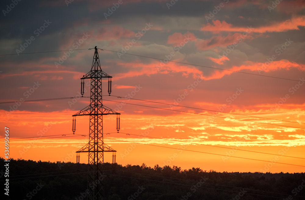 voltage electric pylon and electrical wire with sunset sky. Electricity poles. Power and energy concept.
