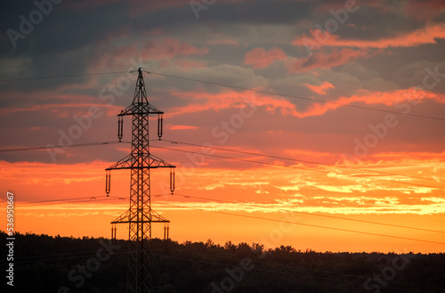 voltage electric pylon and electrical wire with sunset sky. Electricity poles. Power and energy concept.