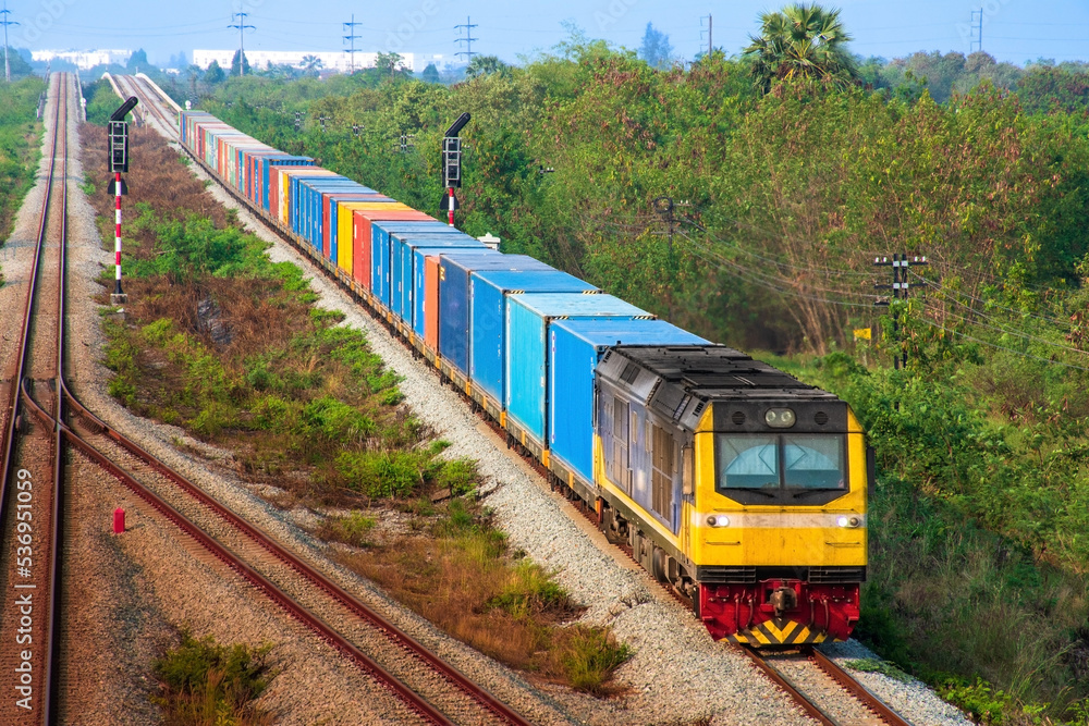 Container-freight train by diesel locomotive on the railway.