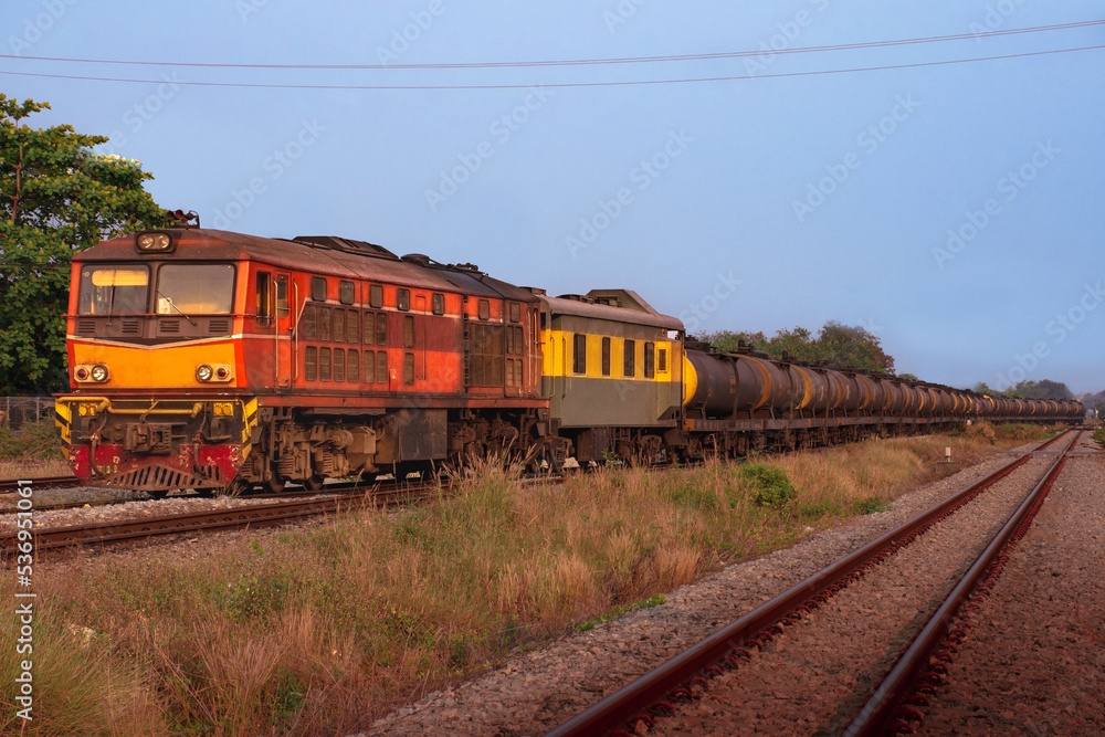 Fototapeta premium Tanker-freight train by diesel locomotive on the railway.