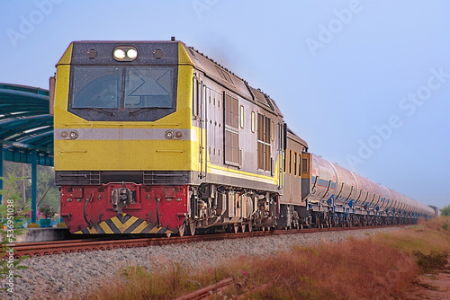 Tanker-freight train by diesel locomotive on the railway.