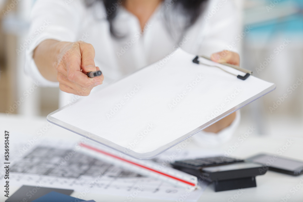 young businesswoman giving contract for you to sign young businesswoman giving contract for you to sign