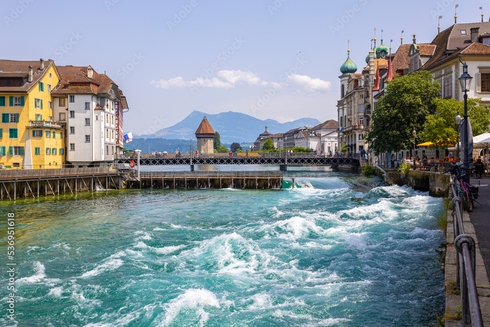 LUCERNE, SWITZERLAND, JUNE 21, 2022 - The rushing waters of the Reuss River in the center of Lucerne, Switzerland