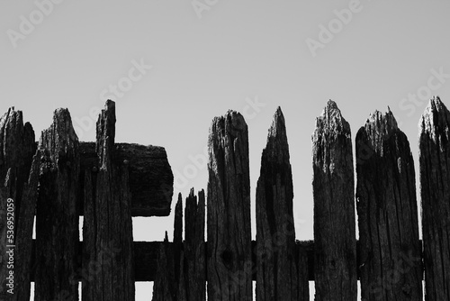 Old wooden fence in a black and white monochrome.