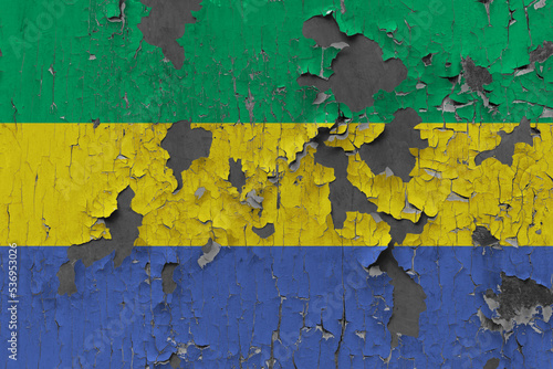 3D Flag of Gabon on an old stone wall background.