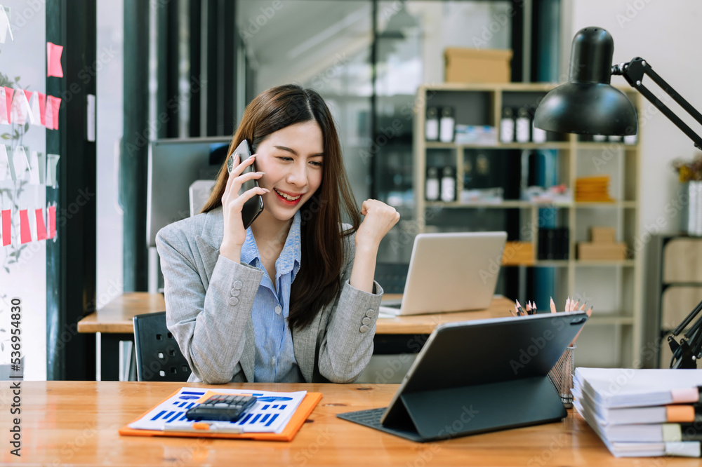 Asian business woman are delighted and happy with the work they do on their tablet, laptop and taking notes at the office. Asian business woman are delighted and happy with the work they do on their tablet, laptop and taking notes at the office.