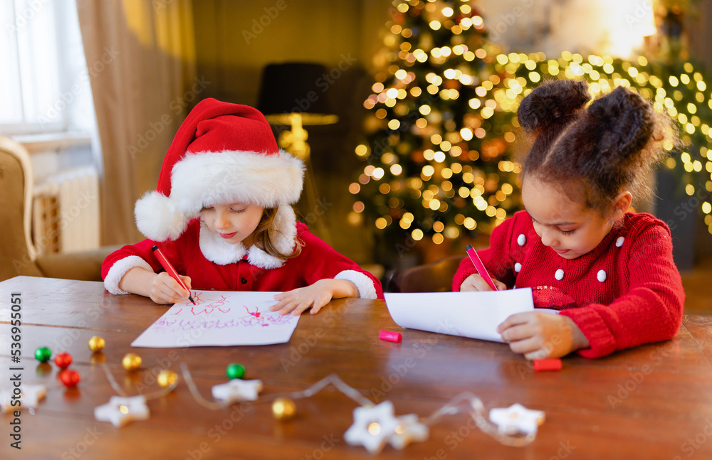 White and Black girls write their cherished wishes and sincere thanks for Santa Claus