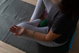 detail of a woman's hands as she relaxes while practicing yoga.