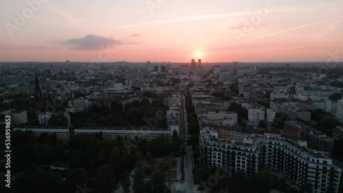 Berlin, Germany - Aerial bird descend drone flight sunset over U Gleisdreieck view to the west of the city - on an evening in center of the city with residential buildings - Establisher shot 2022 photo