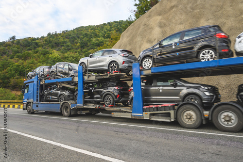 The car transporter truck transports new cars. Automotive industry - production and sale of new cars. No brand or logo.