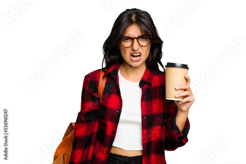 Young student Indian woman holding a take away coffee isolated screaming very angry and aggressive.