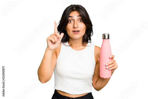 Young Indian woman holding a thermo isolated having an idea, inspiration concept.