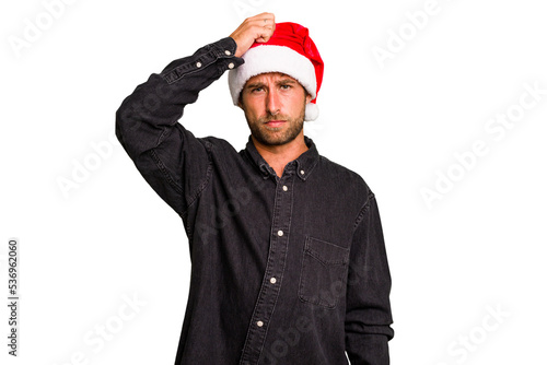 Young caucasian man celebrating Christmas wearing a santa hat isolated being shocked, she has remembered important meeting.