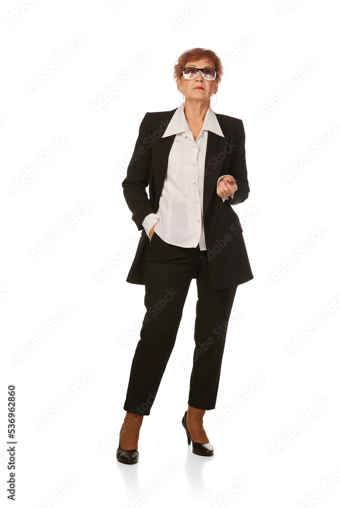 Portrait of confident senior executive manager. Stylish middle age woman in black business suit posing isolated on white background Portrait of confident senior executive manager. Stylish middle age woman in black business suit posing isolated on white background