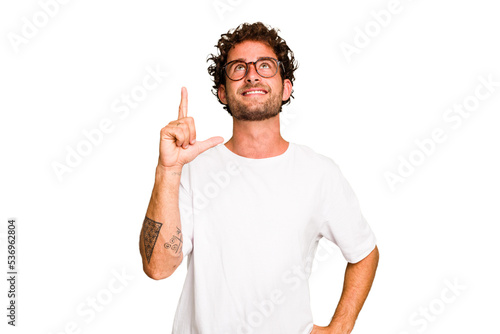 Bild auf Leinwand Young caucasian curly hair man isolated Young caucasian man with curly hair isolated indicates with both fore fingers up showing a blank space
